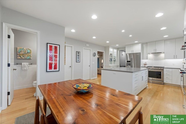 dining space featuring recessed lighting and light wood finished floors