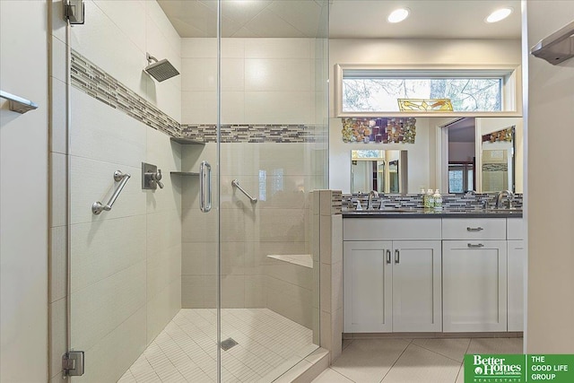 bathroom featuring double vanity, tile patterned floors, a stall shower, and recessed lighting