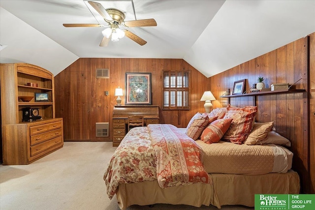 carpeted bedroom featuring a ceiling fan, vaulted ceiling, wood walls, and visible vents