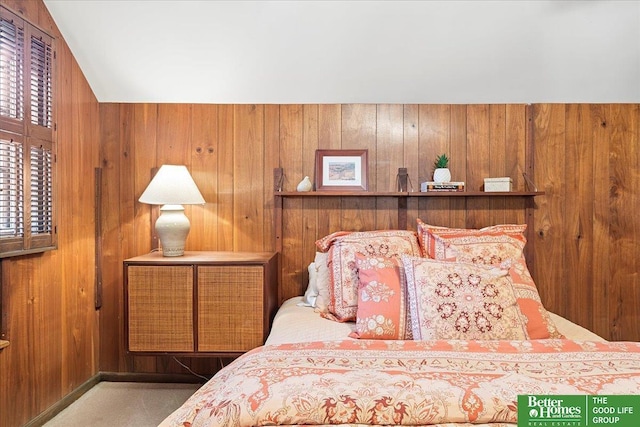 bedroom featuring wood walls and carpet flooring