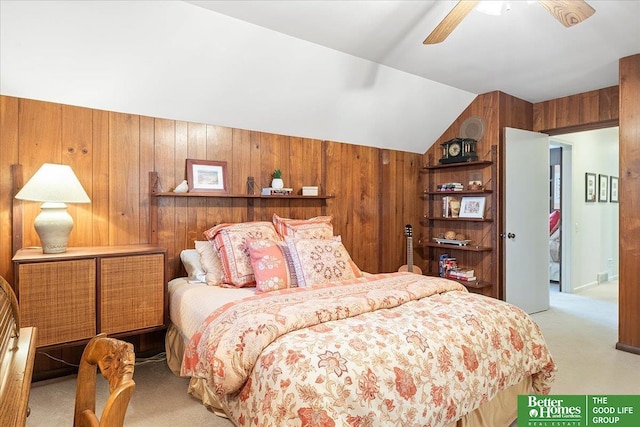 bedroom featuring carpet floors, a ceiling fan, wood walls, and vaulted ceiling
