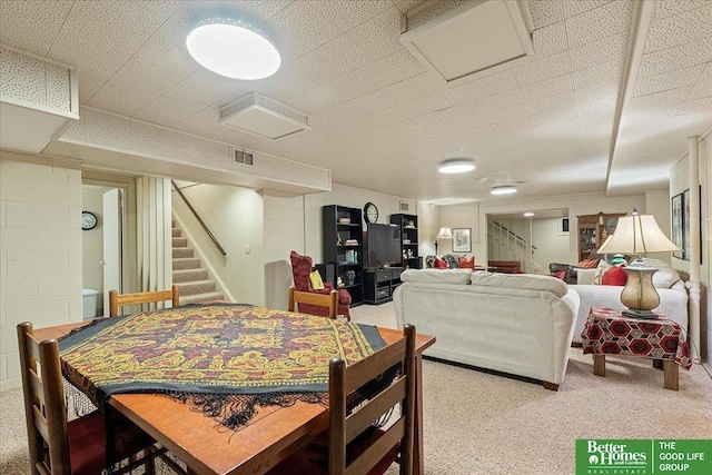 dining space with visible vents, stairs, and light colored carpet