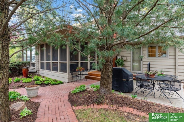 exterior space featuring a sunroom and a patio area