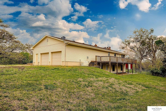 view of side of home with a wooden deck, an attached garage, and a yard