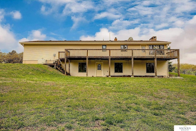 back of house with a yard, a deck, a chimney, and stairs