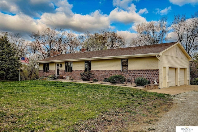 single story home featuring a front yard, a chimney, brick siding, an attached garage, and driveway