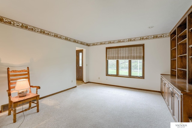 unfurnished room with baseboards and light carpet