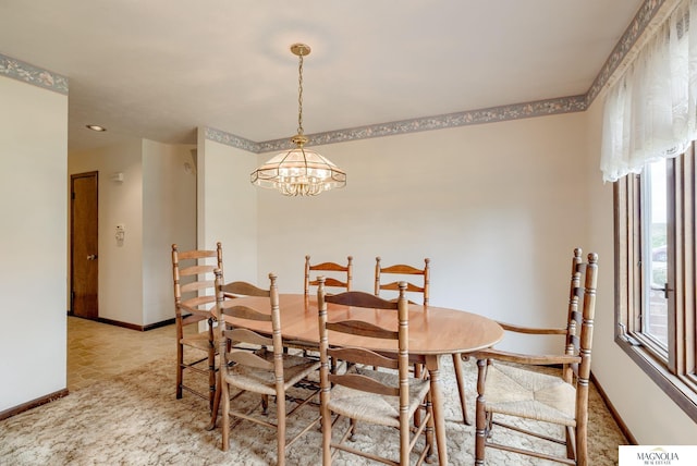 dining room featuring baseboards and a notable chandelier