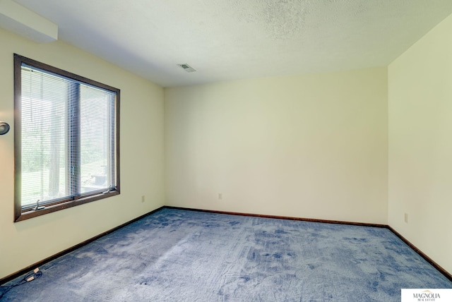 unfurnished room featuring visible vents, carpet, and baseboards