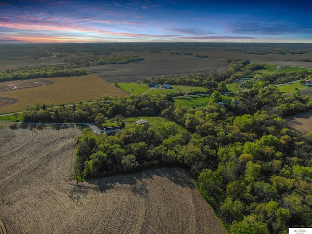 aerial view at dusk featuring a rural view