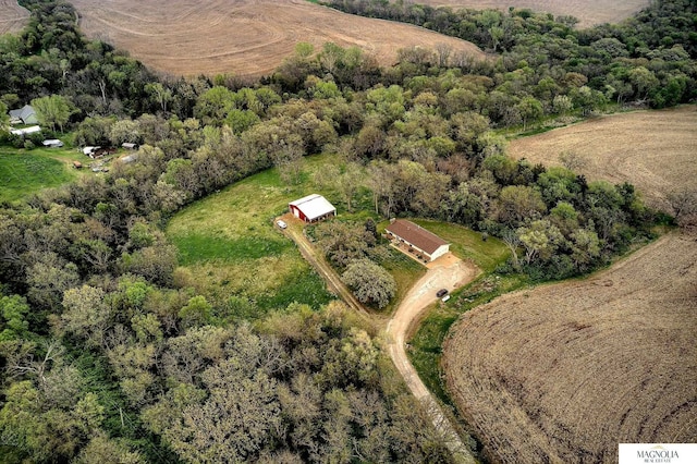 aerial view featuring a rural view and a wooded view