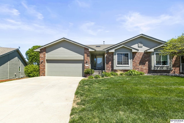 ranch-style home with a garage, a front yard, driveway, and brick siding