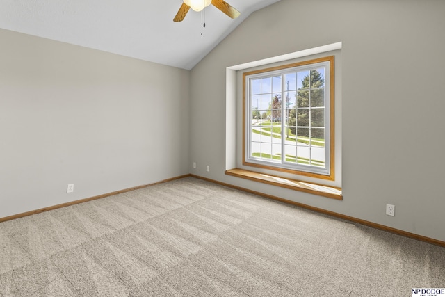 empty room featuring carpet floors, baseboards, a ceiling fan, and lofted ceiling