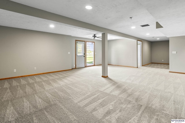 below grade area featuring baseboards, recessed lighting, visible vents, and light carpet
