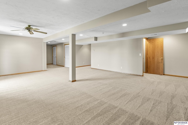 finished below grade area featuring recessed lighting, baseboards, and light colored carpet