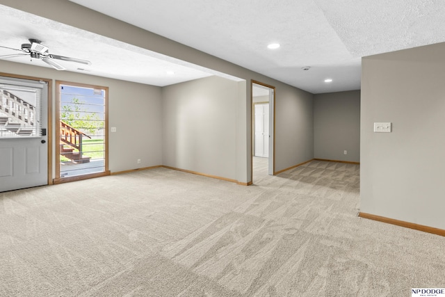 carpeted spare room with baseboards, recessed lighting, a textured ceiling, and ceiling fan