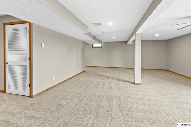 finished below grade area featuring visible vents, carpet flooring, baseboards, and recessed lighting