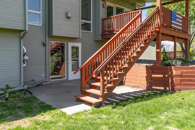 exterior space with a yard, a wooden deck, and a patio area