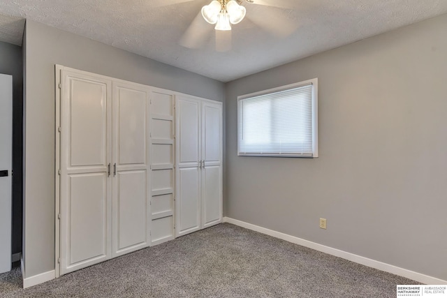 unfurnished bedroom with carpet flooring, baseboards, and ceiling fan