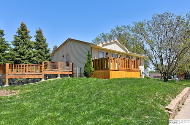 view of side of home with a yard and a deck