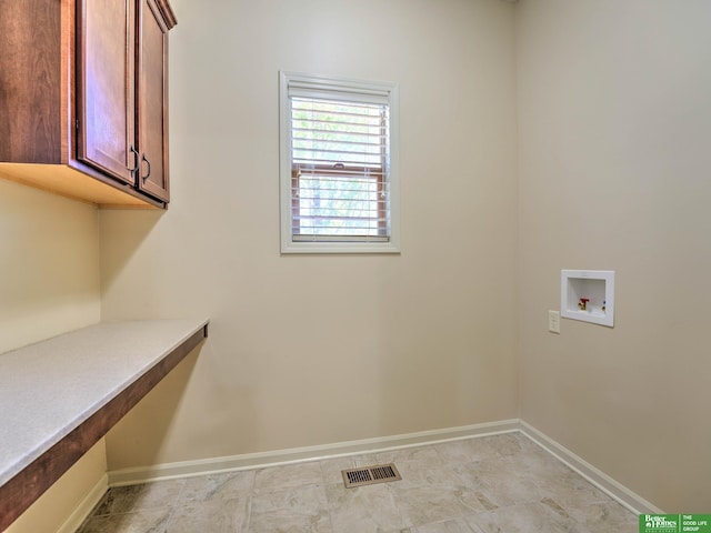 laundry area with cabinet space, washer hookup, visible vents, and baseboards