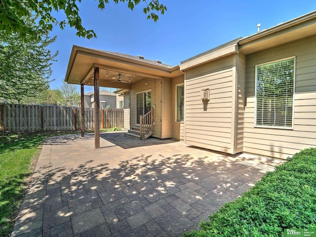 view of patio / terrace featuring ceiling fan, fence, and entry steps
