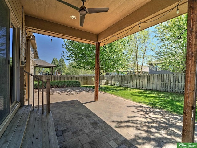 view of patio with a fenced backyard and a ceiling fan