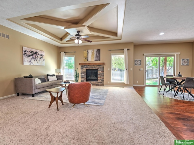 living area with carpet floors, a ceiling fan, baseboards, and visible vents