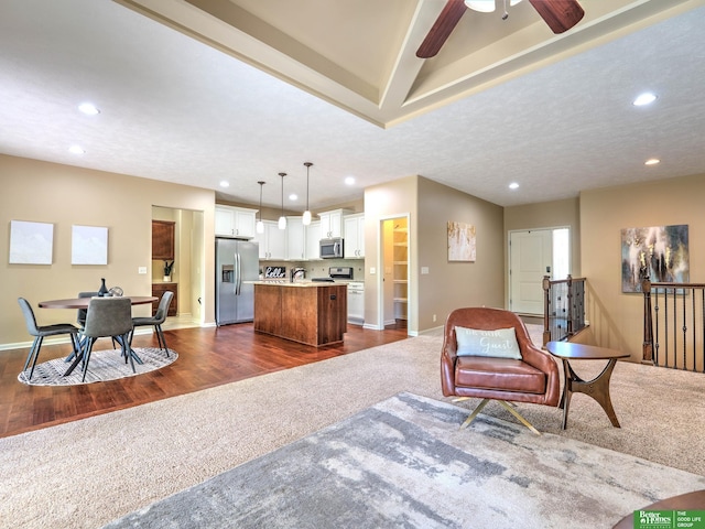 living room featuring a ceiling fan, baseboards, dark colored carpet, dark wood-style floors, and recessed lighting