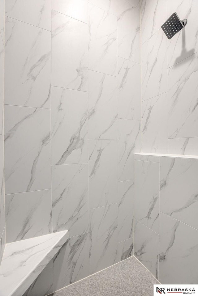 full bath featuring a tile shower