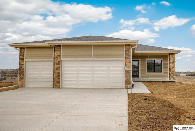 16014 Daniel St, Bennington, NE 68007 - prairie-style home with a garage, a shingled roof, concrete driveway, and stone siding