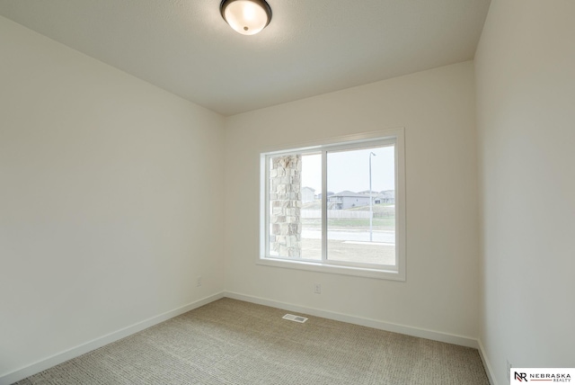 16014 Daniel St, Bennington, NE 68007 - spare room featuring visible vents, baseboards, and light colored carpet