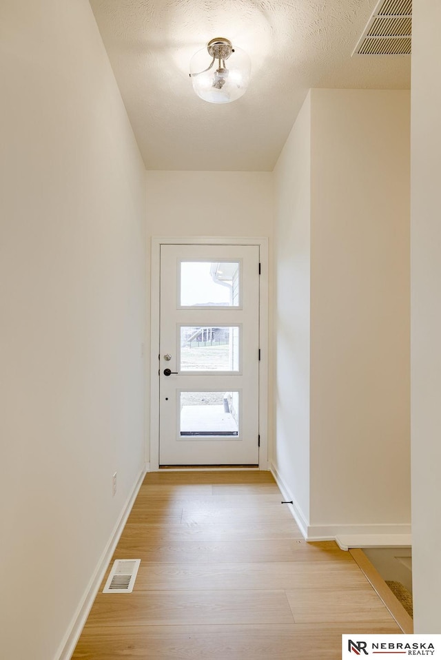 16014 Daniel St, Bennington, NE 68007 - doorway featuring baseboards, light wood-style flooring, and visible vents