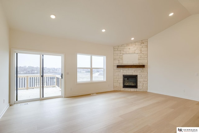 16014 Daniel St, Bennington, NE 68007 - unfurnished living room featuring light wood-style floors, a wealth of natural light, visible vents, and lofted ceiling