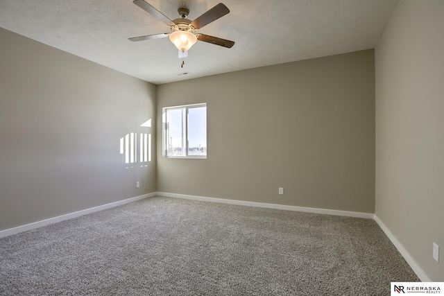 unfurnished room with visible vents, carpet flooring, baseboards, and ceiling fan