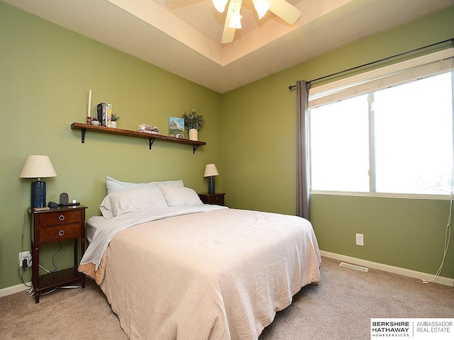 bedroom with visible vents, baseboards, ceiling fan, and light colored carpet