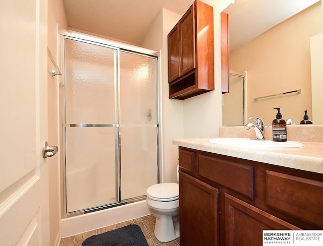 bathroom with vanity, tile patterned floors, toilet, and a shower stall