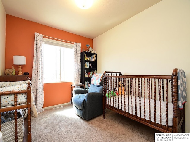 carpeted bedroom featuring visible vents and baseboards