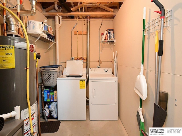 clothes washing area featuring water heater, laundry area, and washing machine and clothes dryer
