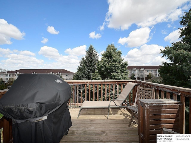 wooden terrace featuring a residential view and grilling area