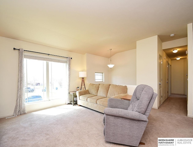living room featuring baseboards and light carpet