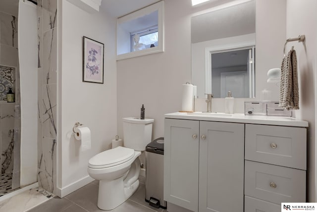 full bathroom featuring a marble finish shower, baseboards, vanity, and toilet