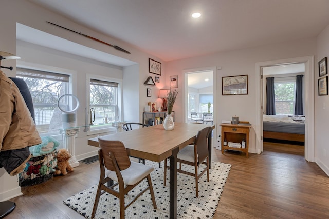 dining space with baseboards, recessed lighting, wood finished floors, and visible vents