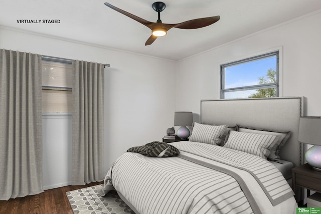 bedroom with crown molding, ceiling fan, and dark wood-style floors