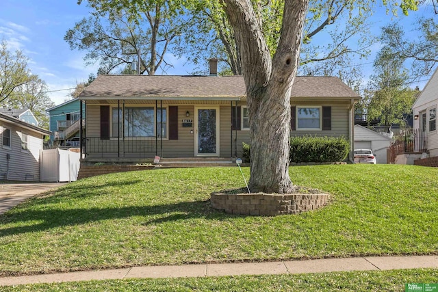 ranch-style house featuring a porch and a front lawn