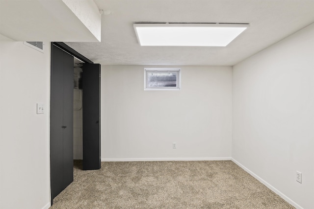 below grade area featuring baseboards, visible vents, and carpet