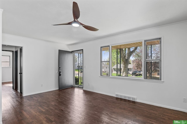unfurnished room featuring visible vents, a ceiling fan, baseboards, and wood finished floors