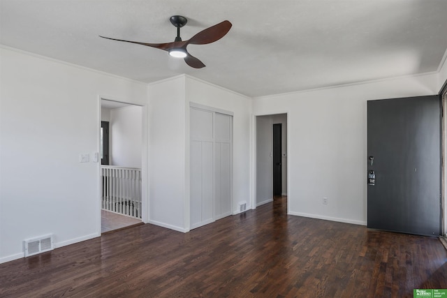 interior space featuring visible vents, ornamental molding, baseboards, and wood finished floors