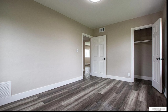 3309 S 32nd Ave, Omaha, NE 68105 - unfurnished bedroom with baseboards, a closet, dark wood-style flooring, and visible vents