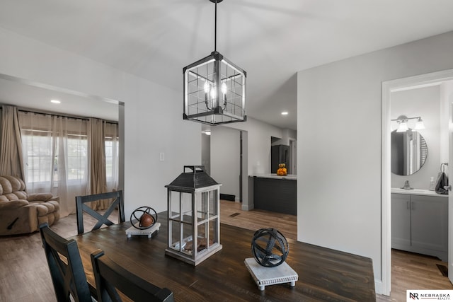 dining room with recessed lighting, wood finished floors, and a chandelier